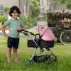 image of a boy in a green shirt holding a pink dolls pram