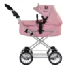 Daisy Chain Destiny Travel System Pram in Classic Pink fabric. Shown in pram mode. Photo shows the pushchair on a front facing angle with the handle at the front of the photo. Hood is up and is pink with accents of Silver metal with a black and pink flower rosette and an with an embroidered Daisy Chain logo in silver. Wheels are black and Silver with a shopping basket at bottom of pushchair which is Silver, like the frame. The frame of the pushchair is silver.