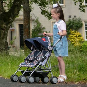 image of a girl pushing a twin dolls pushchair in classic check