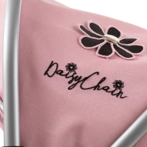 Daisy Chain Pinnacle Double Dolls Pram in Pink fabric for ages 6-13 years old. The pram has a silver frame with black accents. Cot has a black fabric body and pushchair seat has a black body. Both the cot and seat have hoods which are pink with a black and pink daisy that is removable. The cot has a pink apron. Photo shown is a close up of the hood with the rosette.