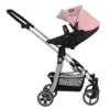 Daisy Chain Pinnacle Double Dolls Pram in Pink fabric for ages 6-13 years old. The pram has a silver frame with black accents. Cot has a black fabric body and pushchair seat has a black body. Both the cot and seat have hoods which are pink with a black and pink daisy that is removable. The cot has a pink apron. Photo shown is the pushchair seat being used as a single pram.
