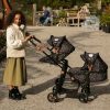 image shows a girl with her double dolls pram that is compatible with our doll high chairs