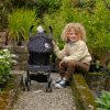 image of a young boy with the daisy chain zipp max dolls pushchair in limited edition twighlight pattern