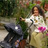 girl with curly hair with her daisy chain zipp twin max dolls pushchair