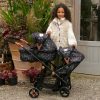 a girl with fluffy coat and a double dolls pushchair