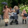 image shows three young girls playing with their dolls pushchair accessory pack