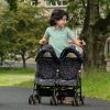 a young boy pushing the daisy chain zipp twin max dolls pushchair in limited edition twighlight pattern