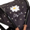 close up image of the hood on a dolls pram, the hood has a daisy logo on it