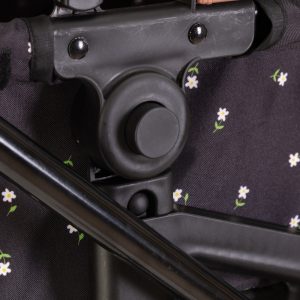 a close up image of a dolls pram showing the clips on the side of the pram