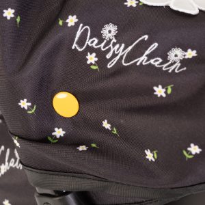 close up image of the daisy chain logo on a pram