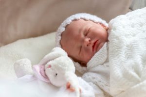 image of a reborn baby doll in white blanket