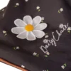 Daisy Chain Zipp Zenith Dolls Pushchair in Limited Edition Twilight fabric. Close up of hood showing the daisy rosette which has yellow petals and a yellow centre. Underneath this is an embroidered Daisy Chain logo in white.