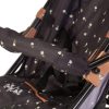 image of dolls pushchair with black and tan colour with a pattern of small white daisys