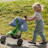 image of a blonde child pushing a blue and green dolls pram