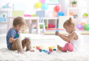 image of two children playing with building blocks