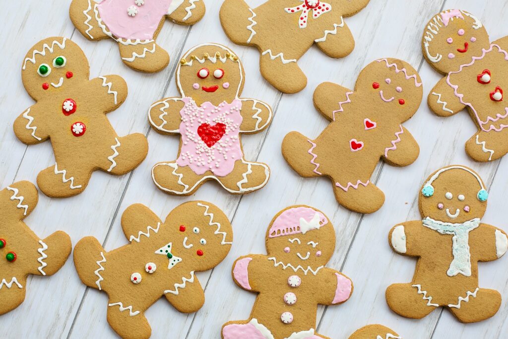 an image of gingerbread people decorated with pink icing