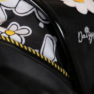 Detail of Daisy Chain Connect Dolls Pram hood showing bumblebee fabric detail and black and yellow striped trim