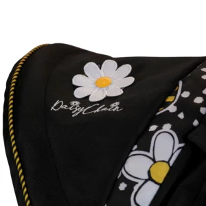 Daisy Chain Little Zipp Dolls Pushchair in Bumblebee fabric - Close up of hood with embroidered Daisy Chain logo with flower rosette sitting above it. In the right corner of the image is the bumblebee fabric print