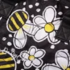Daisy Chain Luxury Tote Bag in Bumblebee fabric. Close up of quilted bumblebee fabric and embroidered white Daisy Chain logo