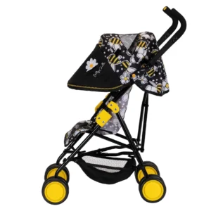 Daisy Chain Zipp Max Dolls Pushchair in Bumblebee fabric shown side on with the handles on the right side. Hood is down and is black at the front of the hood with bumblebee fabric at the top and back of the hood. Wheels are yellow and shopping basket at bottom of pushchair is black