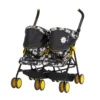 Daisy Chain Zipp Twin Max Dolls Pushchair in Bumblebee fabric. Shown at an angle facing left. The pushchair has 2 seats side-by-side in the bumblebee fabric and two hoods with black fabric at the front and bumblebee fabric at the back of the hoods. Wheels are yellow with black tyres.