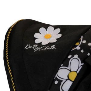 Daisy Chain Zipp Zenith Dolls Pushchair in Bumblebee fabric. Close up of hood showing the daisy rosette which has white petals and a yellow centre. Underneath this is the Daisy Chain logo embroidered onto the black fabric. To the right is a strip of the bumblebee fabric.