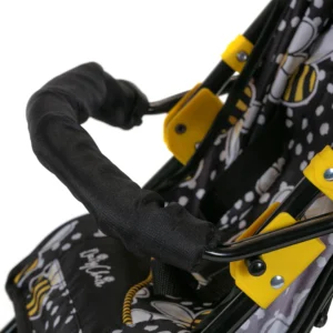 Daisy Chain Zipp Zenith Dolls Pushchair in Bumblebee fabric showing a close up of the seat in bumblebee fabric and the black bumper bar going across the seat.