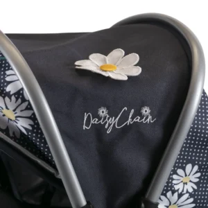 Daisy Chain Connect Dolls Pram in Daisy Dot fabric.. Close up of hood with a white and yellow flower rosette and an embroidered Daisy Chain logo in white