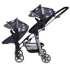 Daisy Chain Pinnacle Double Dolls Pram in Daisy Dot fabric for ages 6-13 years old. Hood is up and is mainly navy blue with accents of daisy's and white polka dots Silver metal with a white and yellow flower rosette and an with an embroidered Daisy Chain logo in white. There is a pushchair seat on the top part of the pram facing away from the handles and a pushchair seat on the bottom facing away from the handle. Wheels are black and Silver with a shopping basket at bottom of pushchair which is black. The frame of the pushchair is silver