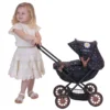 Daisy Chain Pocket Pram in Limited Edition Twilight - For ages 18 months - 3 years. Black frame with rose gold accents, black cot and limited edition twilight hood. Girl stood next to it in a summer dress.